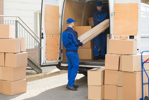 Team safely loading items into a van during a removals job