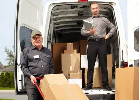 Man and van loading furniture in a Cricklewood street
