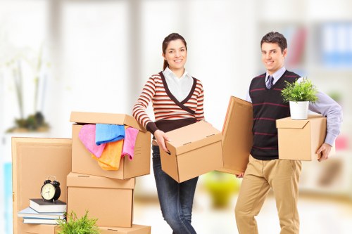 Moving boxes and furniture being loaded into a van