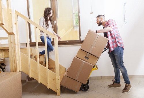 Loading furniture into a van during a Cricklewood removal job