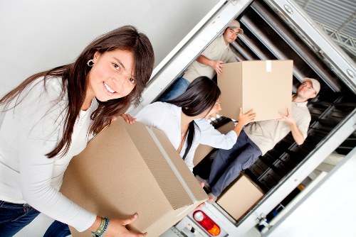 Furniture loading into a moving truck near Cricklewood